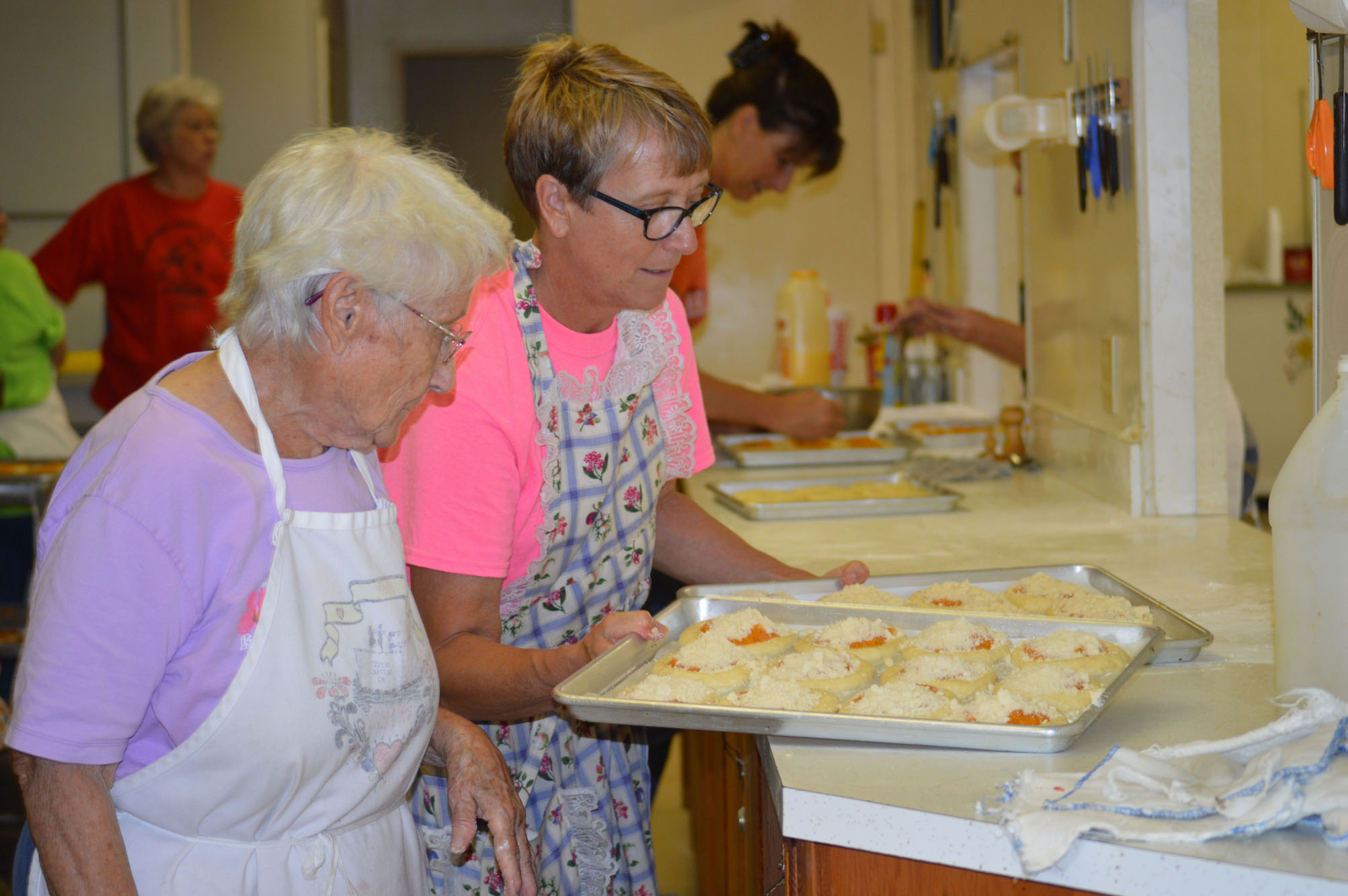 June Calahan and Julia Mason get ready to put Kolaches in the oven.